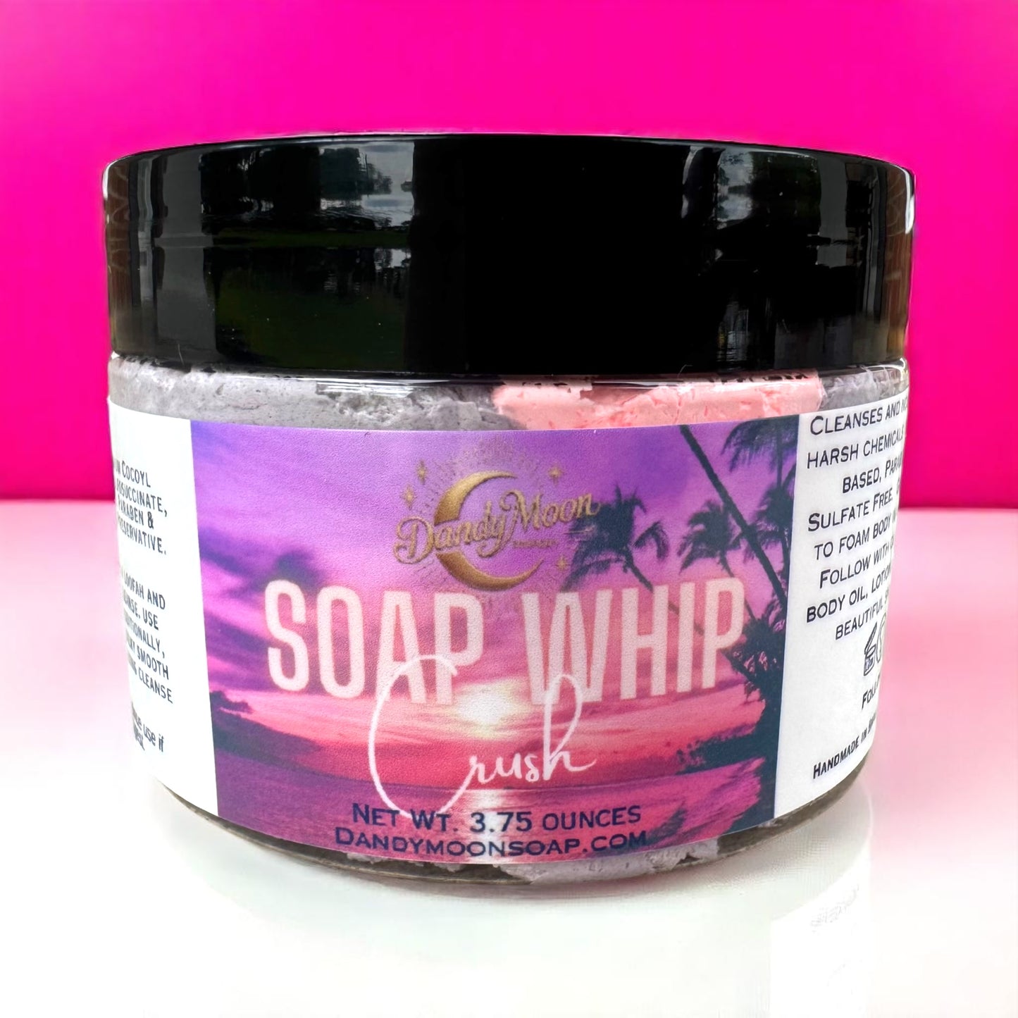 Jar of soap whip with a colorful label on a pink background