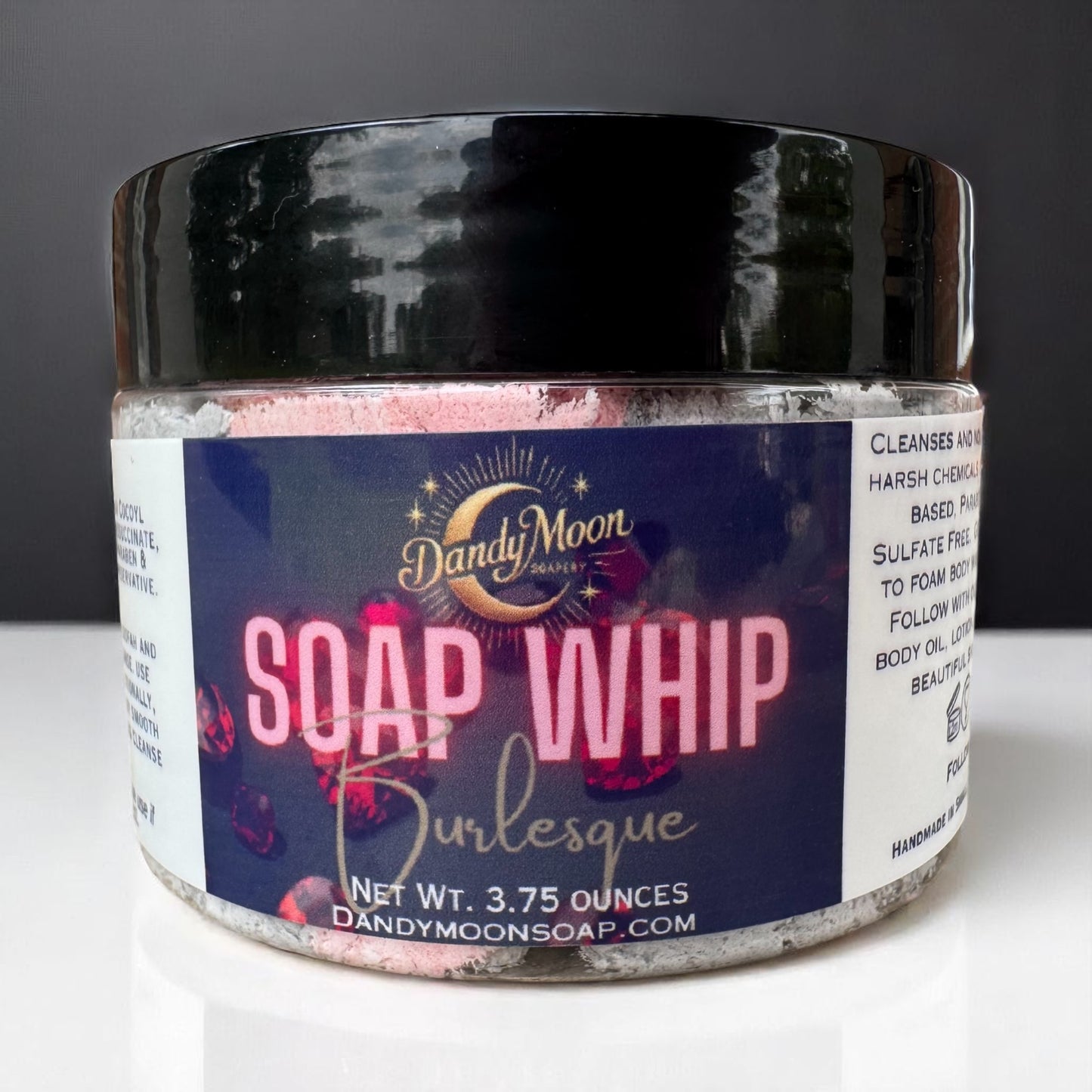 Jar of Dandy Moon Soap Whip Burlesque on a white surface with a dark background