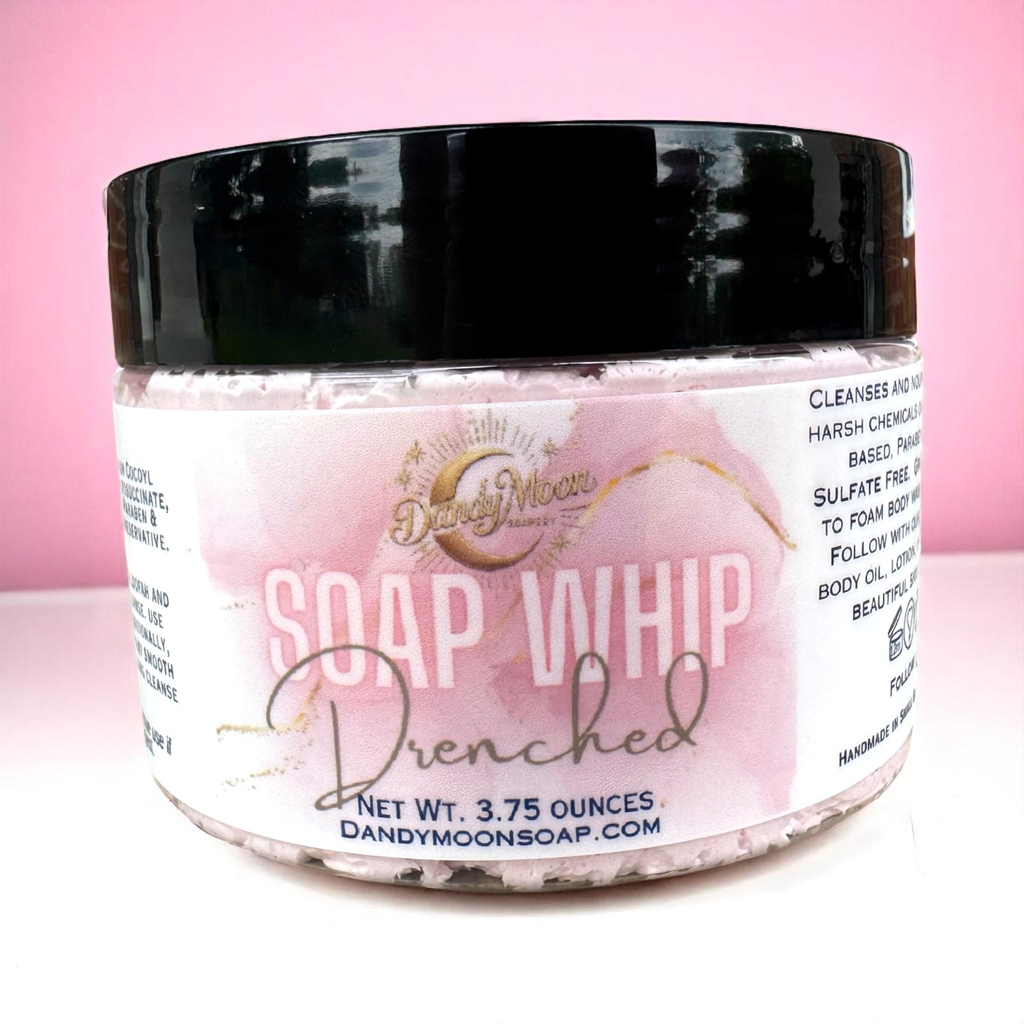 Jar of Soap Whip Drenched scent, with a pink label sitting on a white surface against a pink background