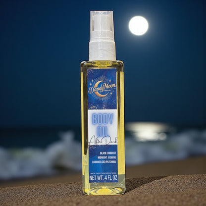 Bottle of Dandy Moon body oil on a beach with waves and moonlight in the background