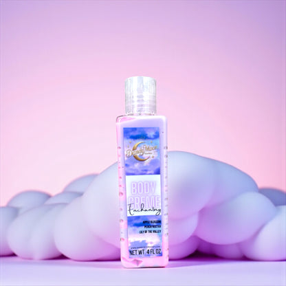 a bottle of body creme lotion in the scent enchanting. the bottle is clear and the lotion inside is swirls of purple and pink. the bottle stands on a light purple surface with a fluffy cloud behind it in the same light purple. the background is a gradient purple and pink. 