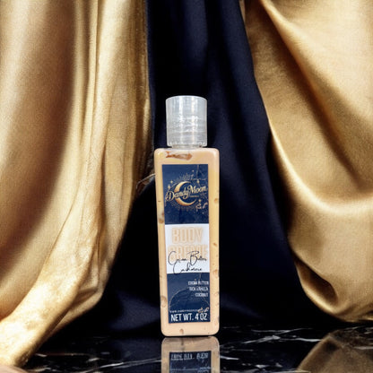 a bottle of body creme lotion in the scent cocoa butter cashmere stands on a black marble surface, against a background of black and gold satin fabric drapes