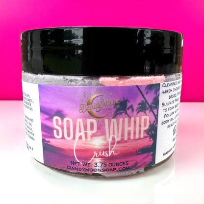 Jar of soap whip with a colorful label on a pink background