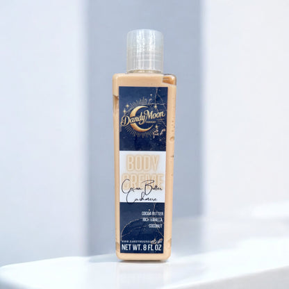 a bottle of body creme lotion in the scent cocoa butter cashmere stands on a white surface against a white background