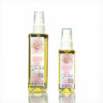 Two bottles of Drenched body oil, one 2 ounce and one 4 ounce bottle, with pink design label, against a white background 