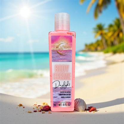 Body creme lotion bottle that is clear with coral colored lotion inside it, on a beach with palm trees and ocean in the background. there are seashells scattered around the bottle of lotion