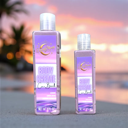 Two bottles of Dandy Moon Body Creme Lotion on a blurred beach background