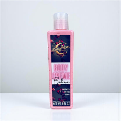 bottle of Dandy Moon body creme lotion, pink in color, on a white background