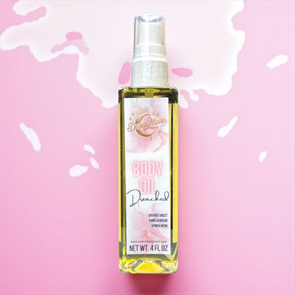 Body oil bottle with a pink label on a pink liquid background