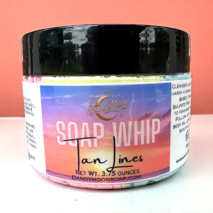 Jar of Soap Whip with colorful label on a white and peach tone background