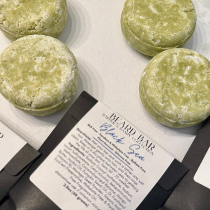 Green beard bars on a white surface with a label in front