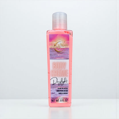 Body Creme lotion bottle in Daylight scent, the bottle is clear and the lotion inside is a coral color, against a white background