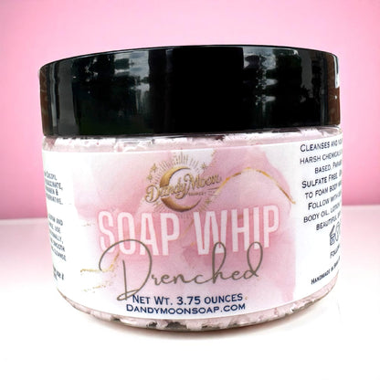 Jar of Soap Whip Drenched scent, with a pink label sitting on a white surface against a pink background