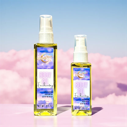 Two bottles of 'Body Oil Enchanting' with a pink and blue gradient cloud background, one bottle is 2 ounces and one bottle is 4 ounces, they are standing on a pink flat surface