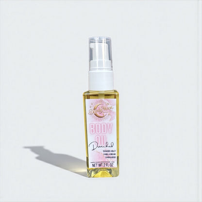 Body oil bottle with a pink and white label against a white background