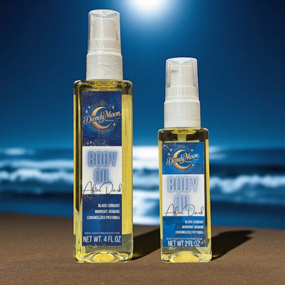 Two bottles of Dandy Moon body oil, one is 2 ounces and one is 4 ounces, on a beach with ocean waves in the background
