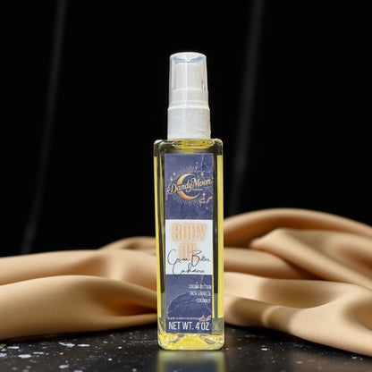 Bottle of body oil with a label on a dark surface and golden beige silk fabric draped in the background