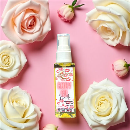 Body oil bottle with red and pink lips design label, surrounded by roses on a pink background