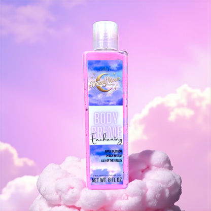 a bottle of body creme lotion in the scent enchanting. the bottle is clear and the lotion inside is swirls of purple and pink. the bottle stands on a cotton candy pink cloud, and the background is gradient shades of purple and pink with clouds. 