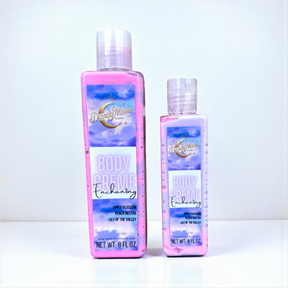 Two bottles of Dandy Moon body creme lotion in the scent enchanting. the bottles are clear and the lotion inside is swirls of pink and purple. the bottles are on a white surface against a white background