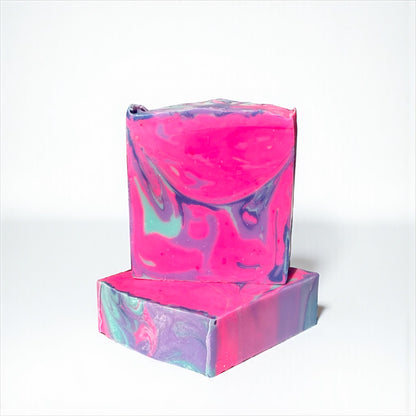 Two marbled pink, purple and blue soap bars on a white background