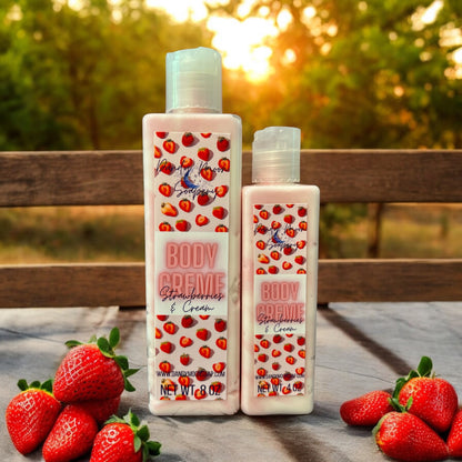 Two bottles of Strawberries & Cream Body Creme Lotion with a wooden background and fresh strawberries nearby. The bottles are clear and the lotion inside is swirls of red and white. 